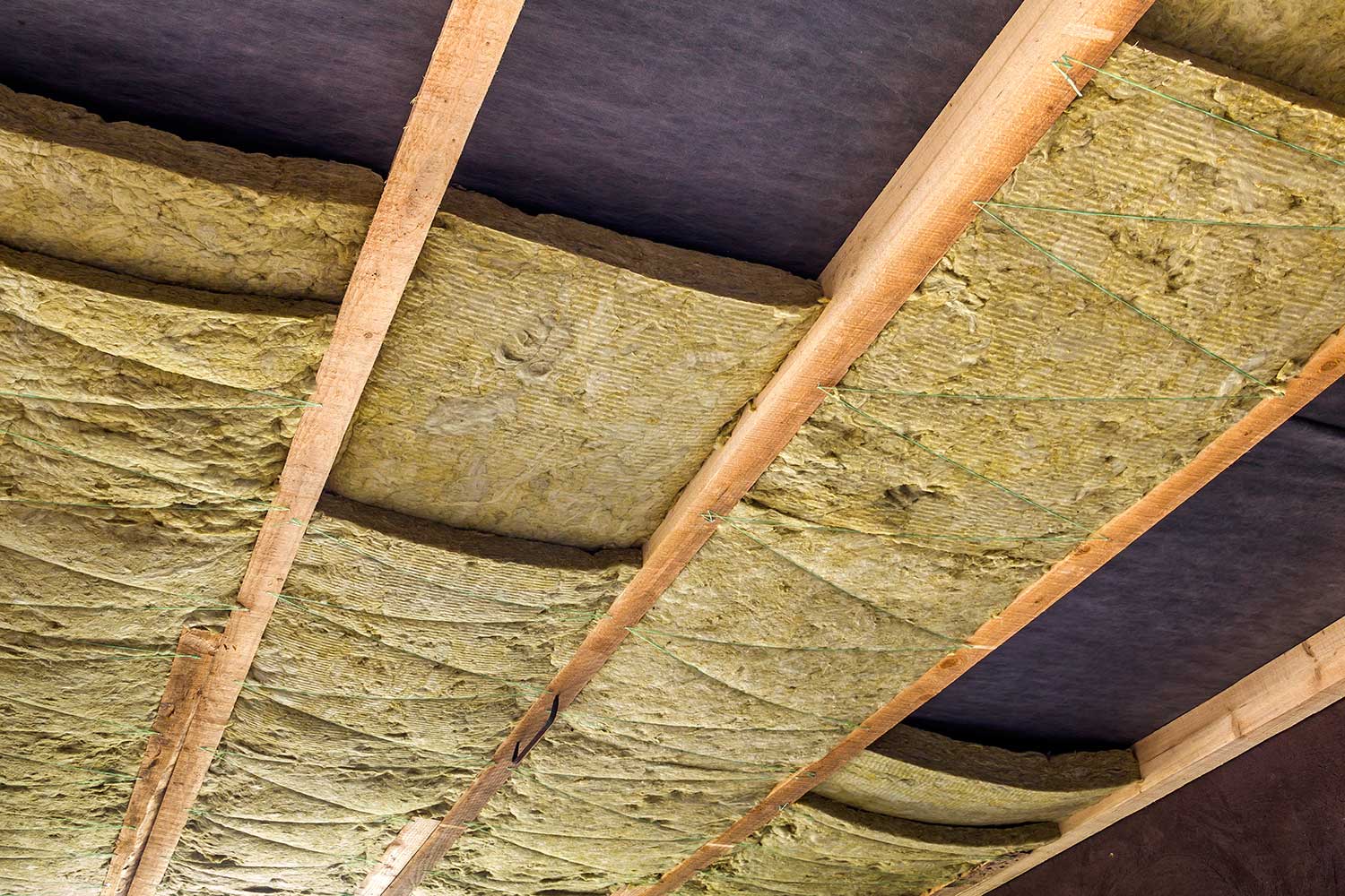 Thermal insulation mineral rock wool installation at the new building attic ceiling
