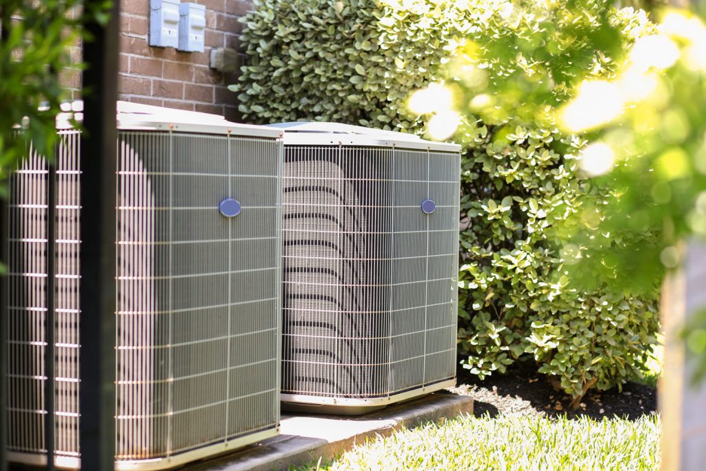 Two air conditioning units photographed outside the house