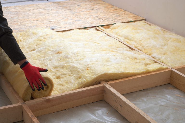 Worker laying out mineral wool in the attic of the house, Can Mineral Wool Insulation Be Left Exposed?