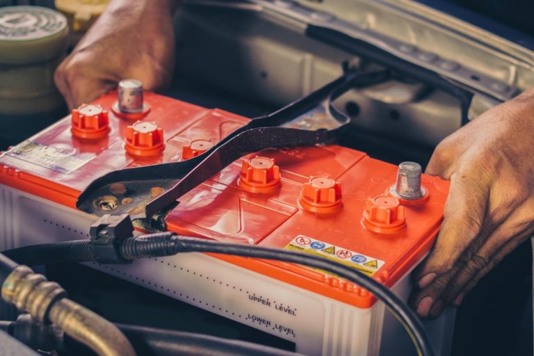 A car mechanic replaces a battery, How Long Can A Car Battery Run An Air Conditioner?