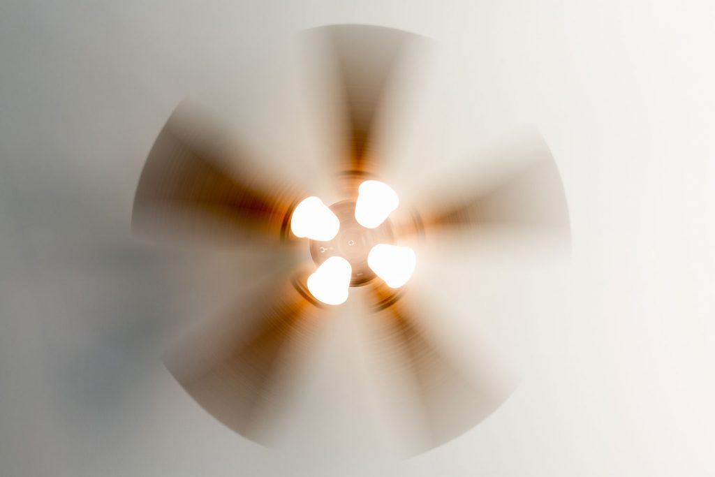 A ceiling fan with fluorescent bulbs
