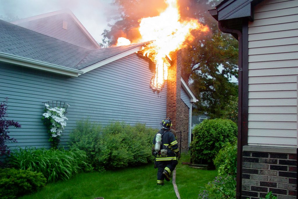 A fireman putting out the fire in the chimney