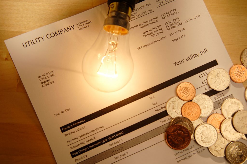 A halogen bulb on top of the utility billing on the table