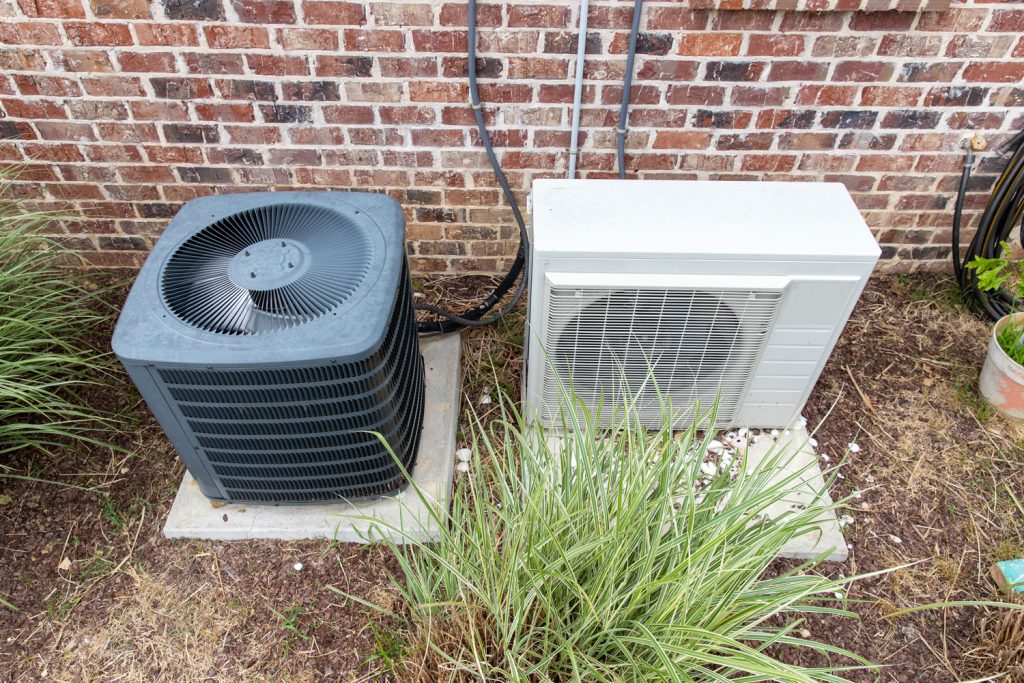 A heat pump and a condenser placed next to each other