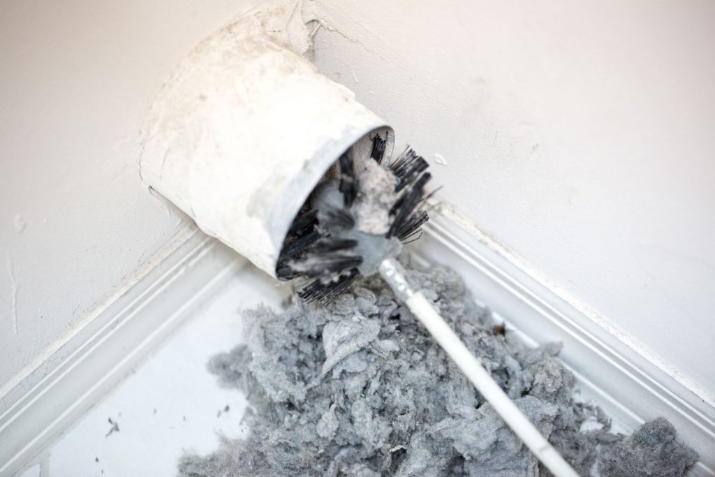 A lint removing brush in the dry vent