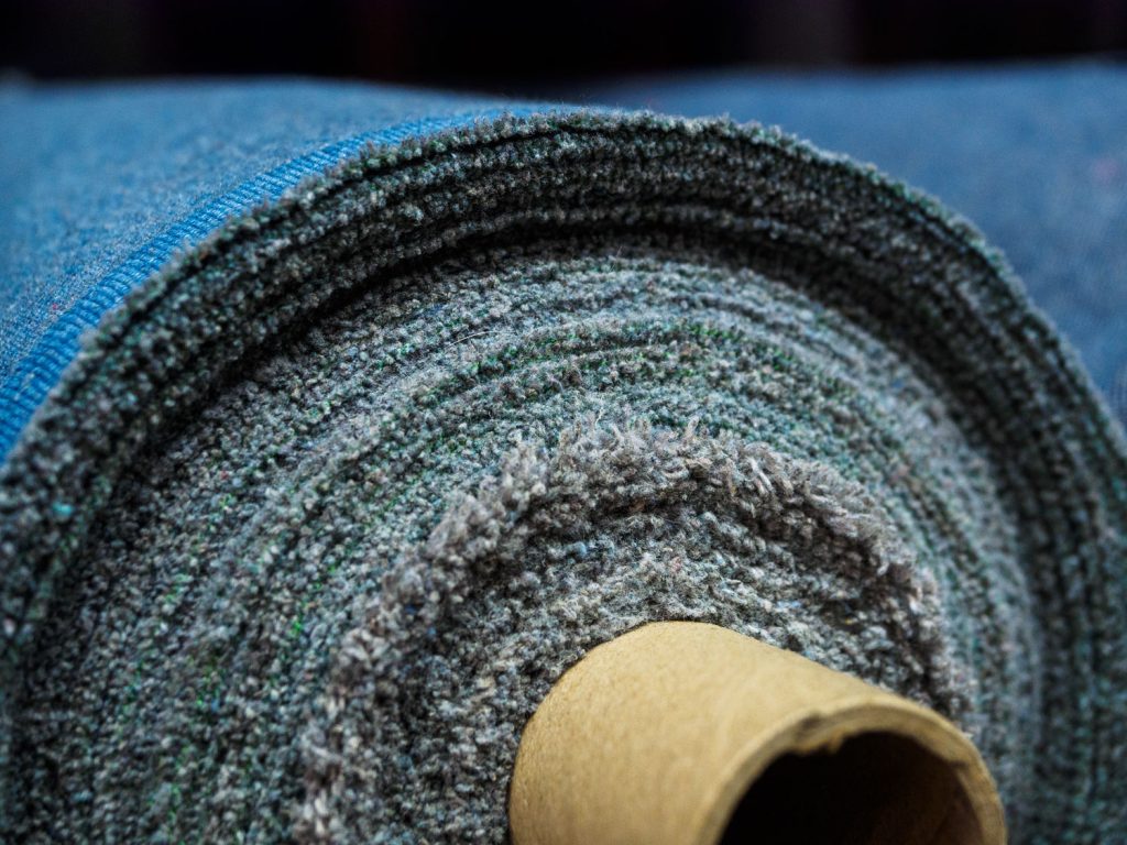 A roll of denim fabric. Woven factory or warehouse.
