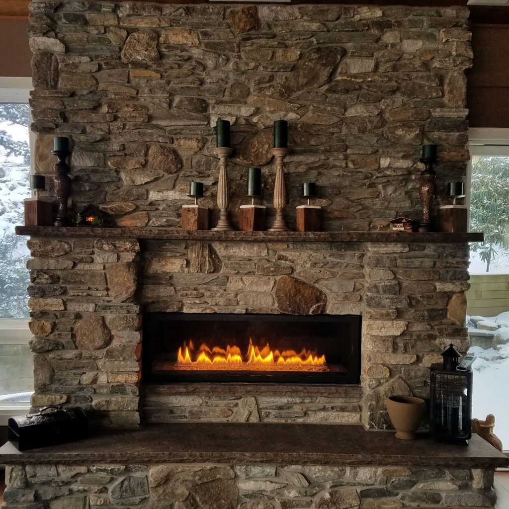 A rustic rock decorated fireplace