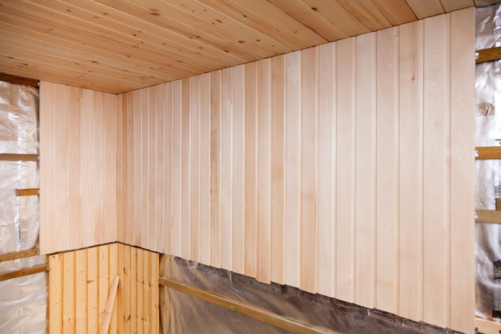 A sauna room under construction with wooden walls
