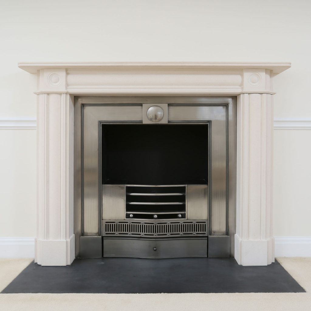 A white fireplace mantel with a stainless heat insulated metal