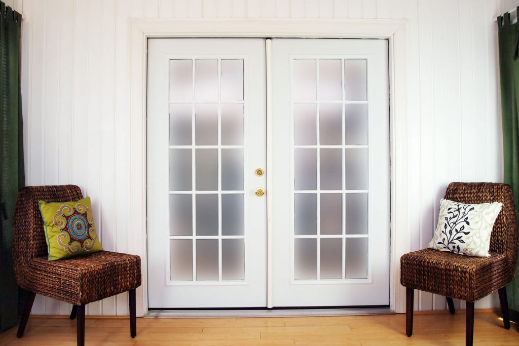 A white French door leading to the patio
