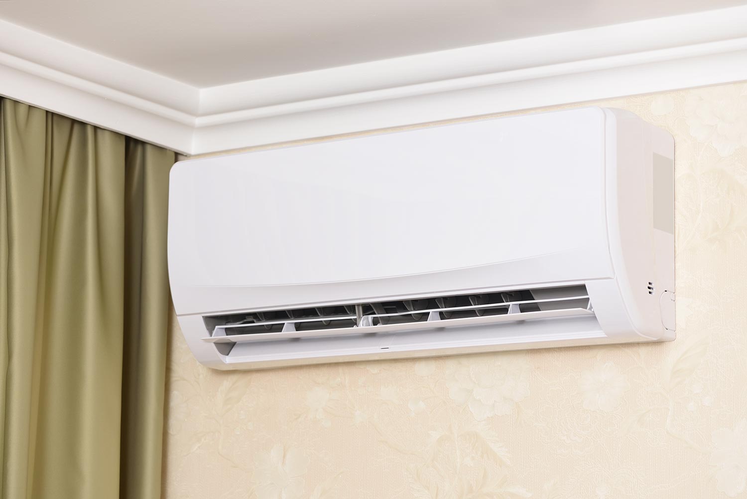 Air conditioner installed at home on the wall under the ceiling