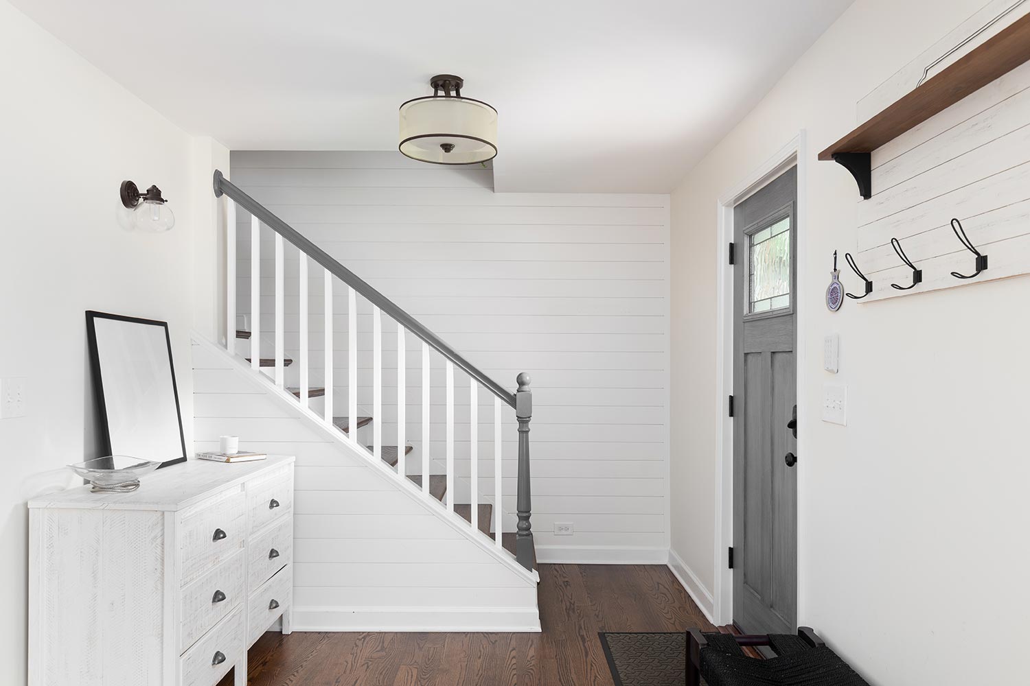 An foyer in a farmhouse style home with shiplap on the wall