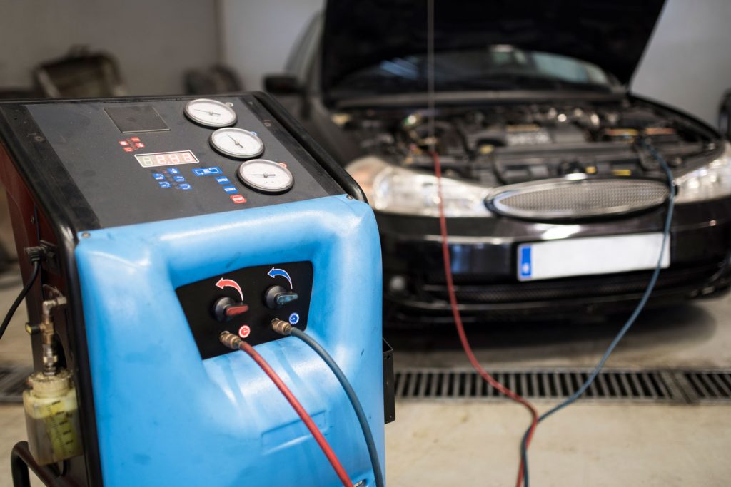 Car battery charger connected to the car batteries