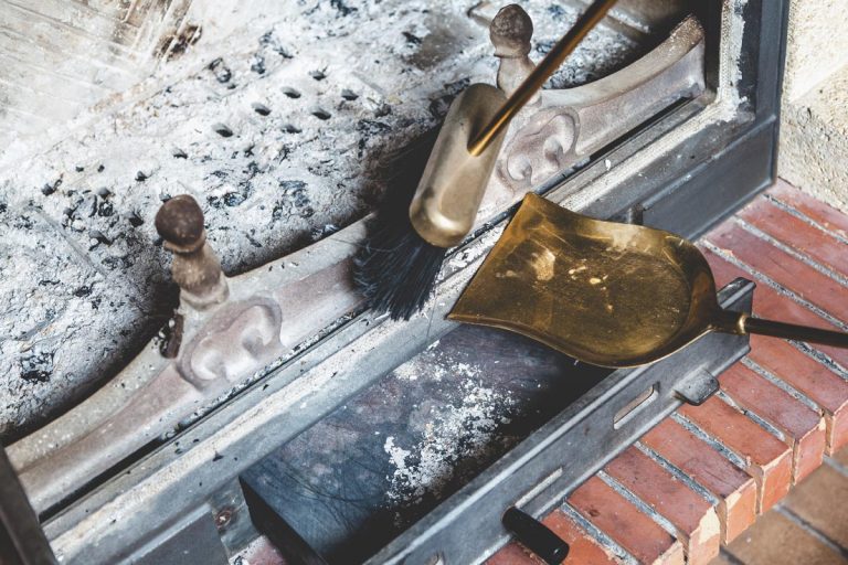 Cleaning the fireplace with an open tray brass brush and shovel, Should You Clean The Ash Out Of A Fireplace?