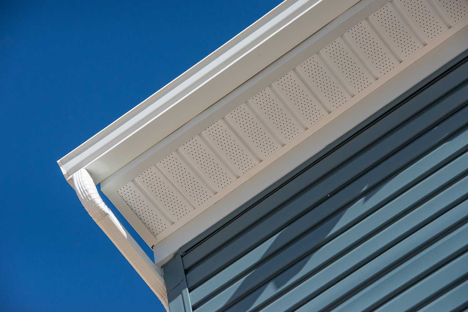 Colonial white gutter guard system, fascia, drip edge, soffit providing ventilation to the attic