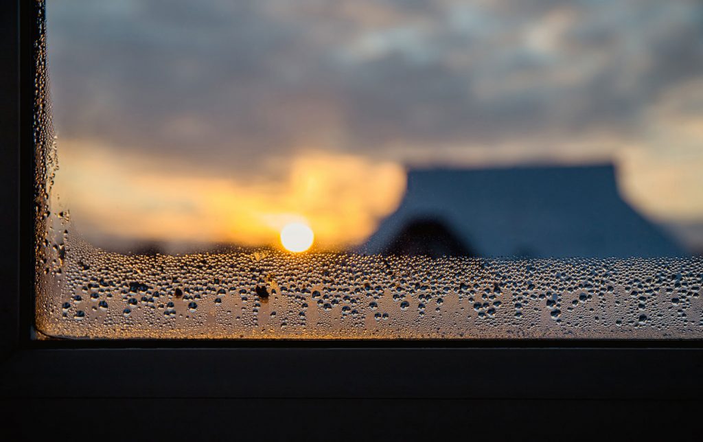 Condensation water drops on home windows in the morning in winter