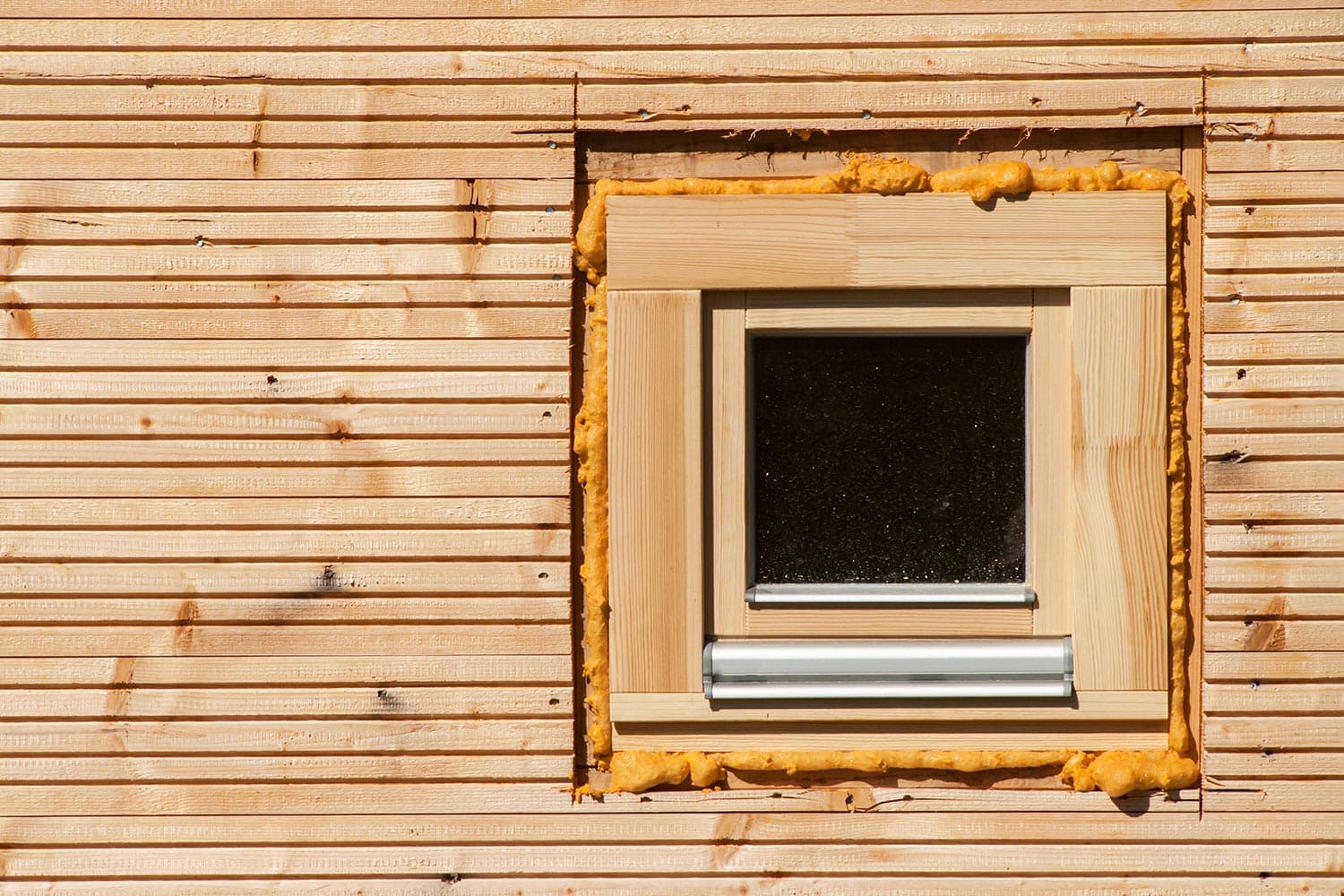 Foam window insulation on wooden construction