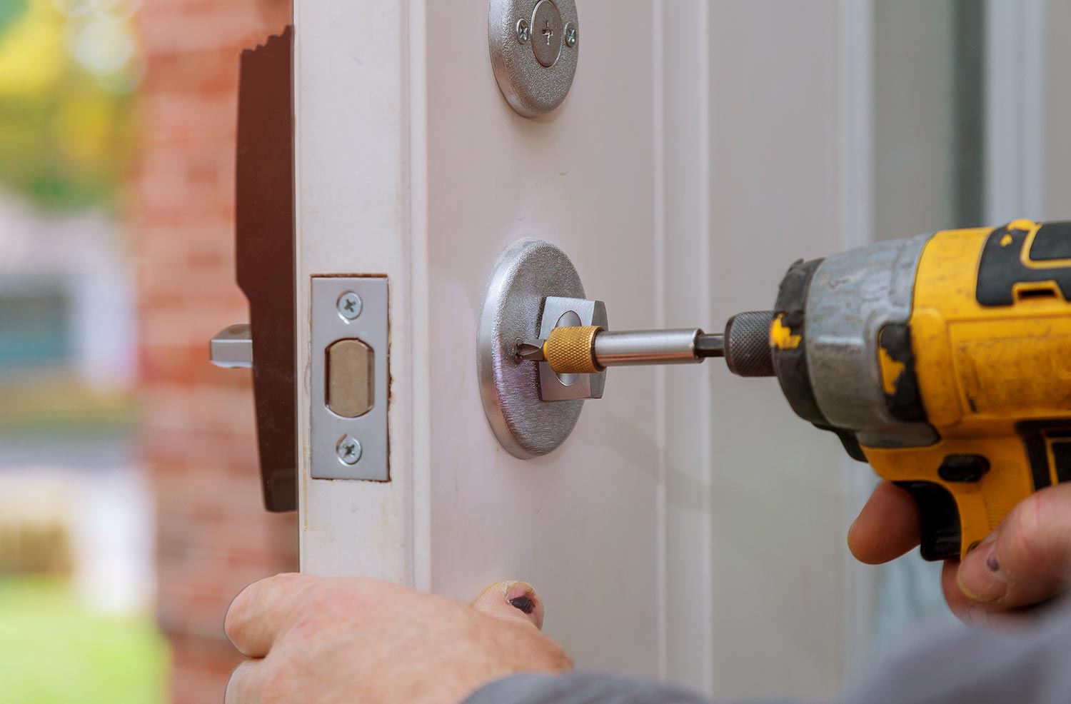 Handyman repair the door lock in worker's hands installing new door locker