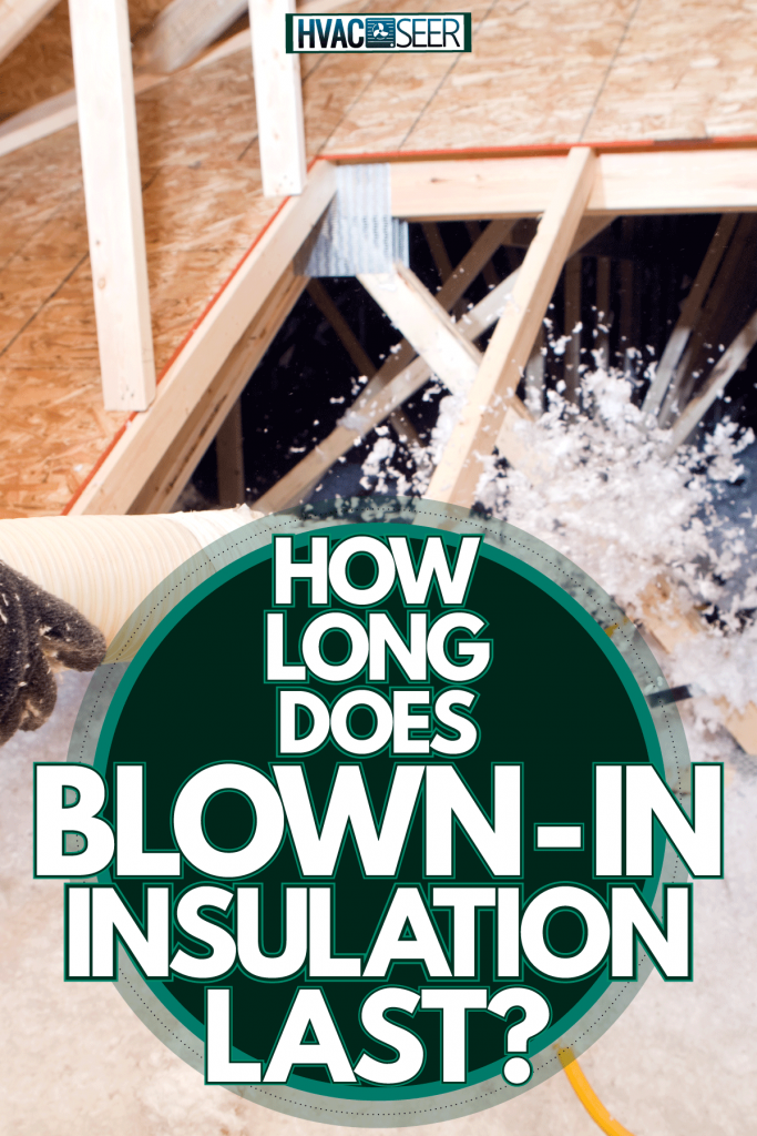 Worker spraying blow-in insulation to the attic floor joist, How Long Does Blown-In Insulation Last?