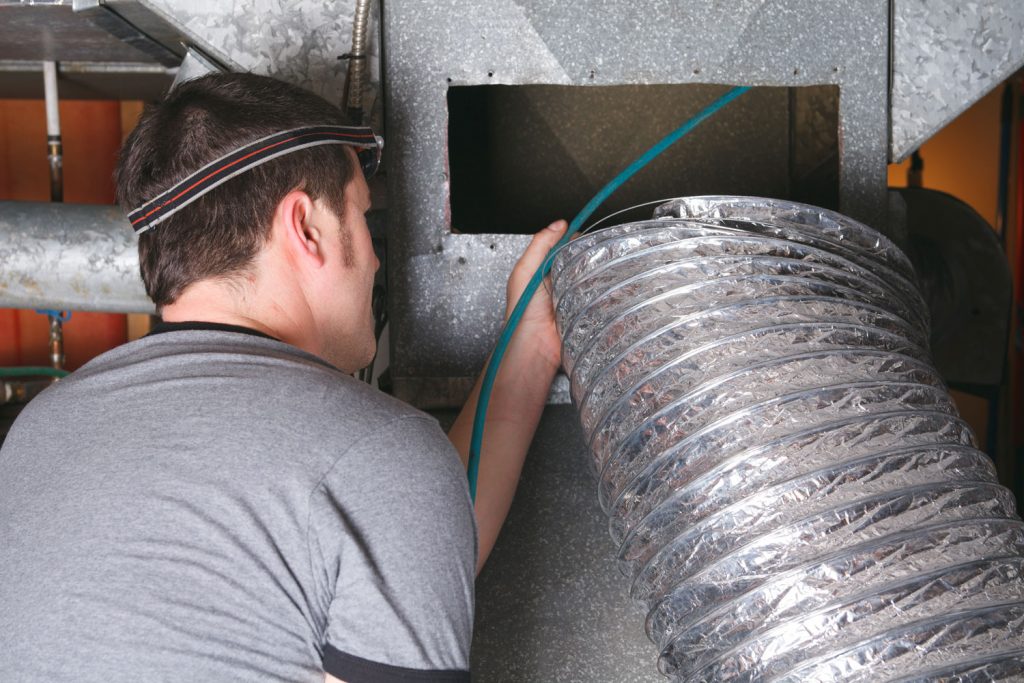 HVAC technician checking the air duct