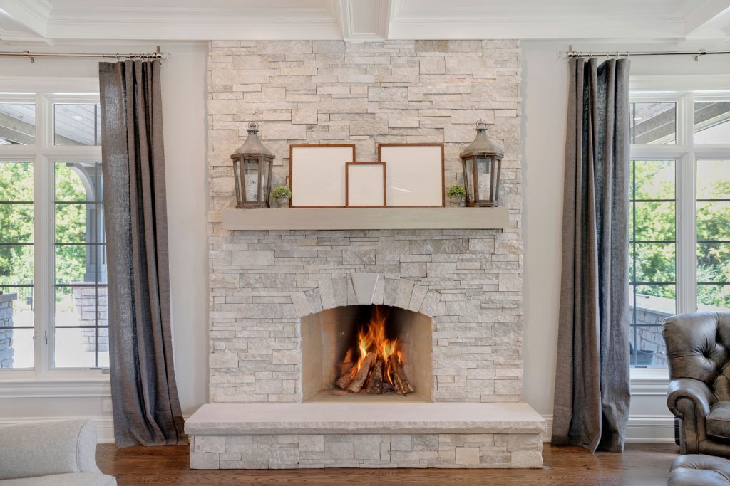 Luxurious and high end living room with decorative stone tiles on the fireplace