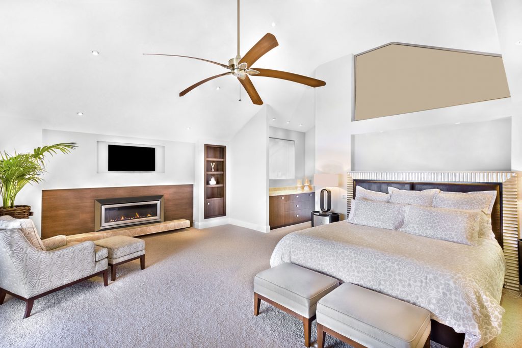 Modern bed area including furniture, television is attached to wall, one chair close to flower pot, fan can see on ceiling, lamp table near wall, perfect lights balancing, very clean area.
