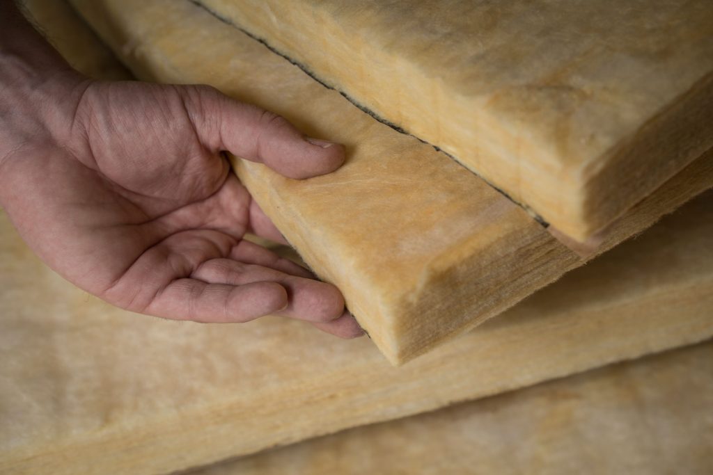 Man holding a block of thermal insulation
