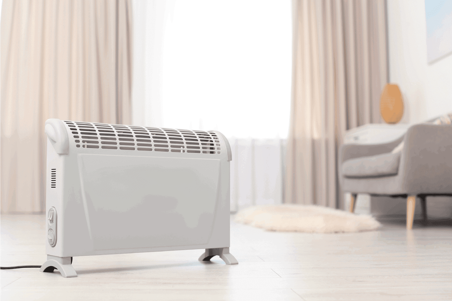 Modern electric heater on floor at home