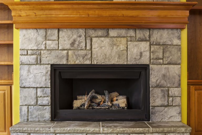 Natural Gas Insert Fireplace built with stone and wood, Should Gas Fireplaces Be Serviced?