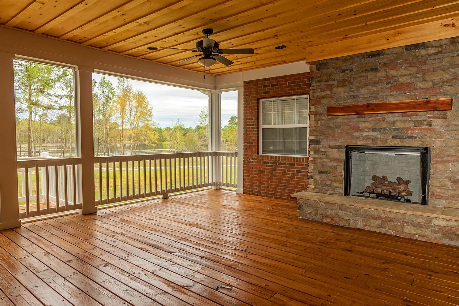 New backyard deck with fireplace overlooking lake