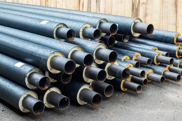 New black insulated steel pipes at municipal construction site, How To Insulate A Main Water Line Pipe