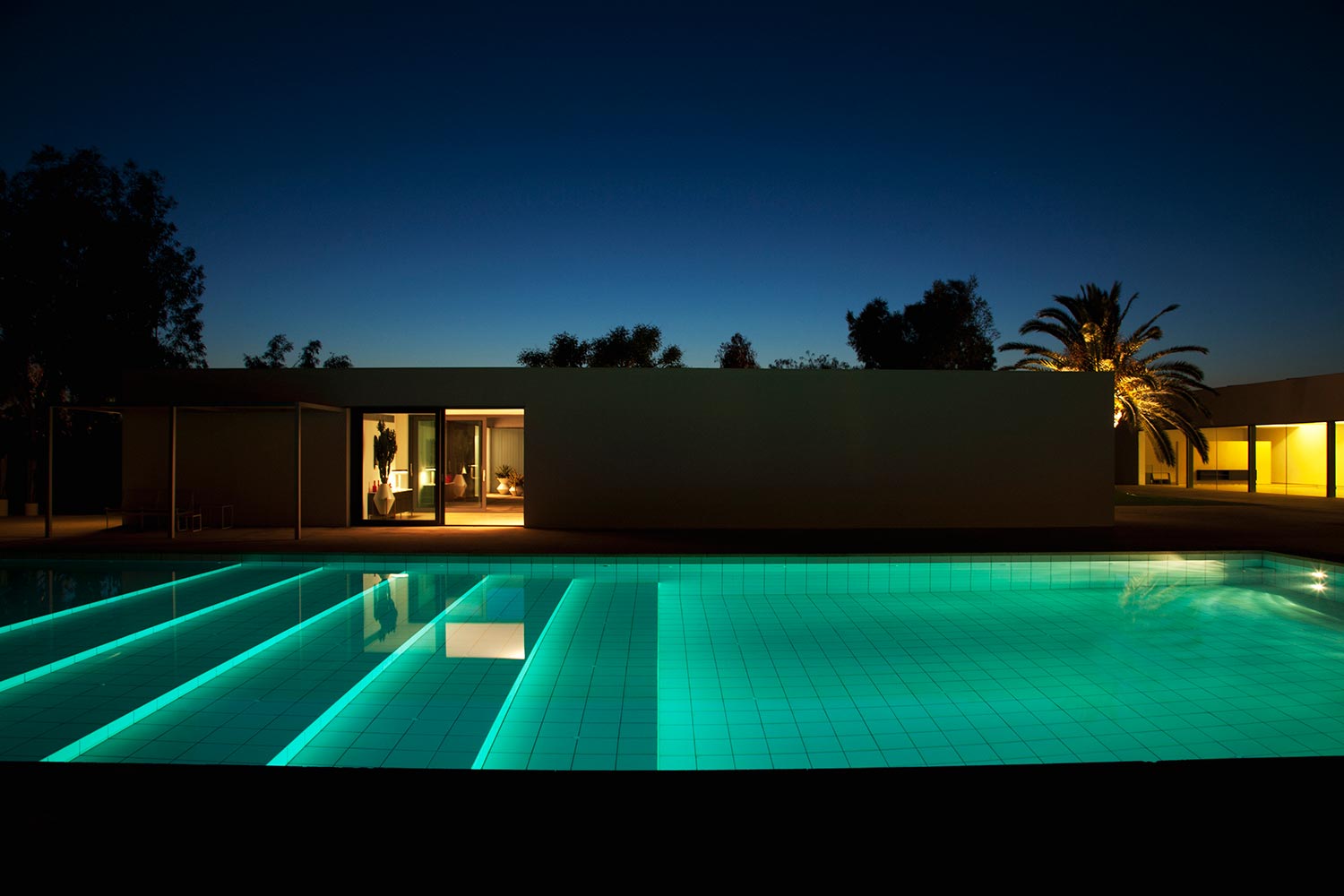 Pool outside modern house at twilight