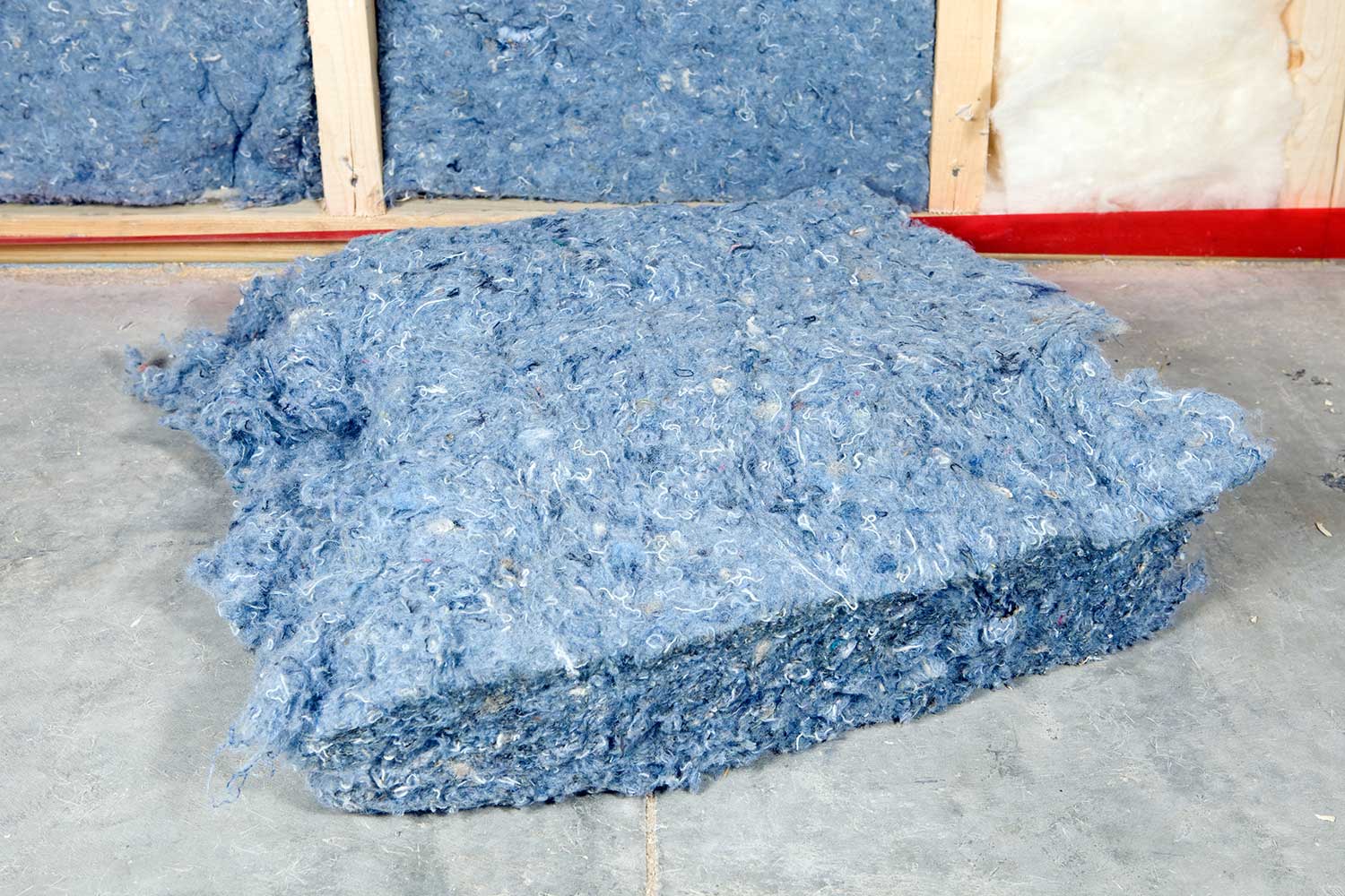 Recycled blue jean denim insulation near wall frame