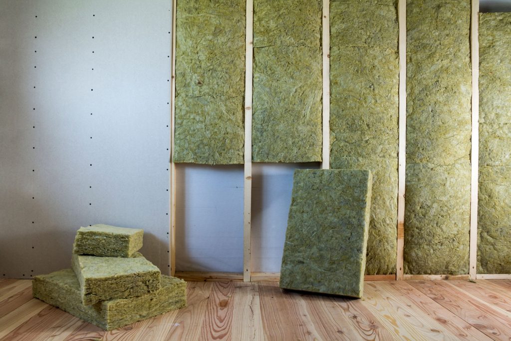 Rock wool and fiberglass insulation between the wooden framing of the living room wall