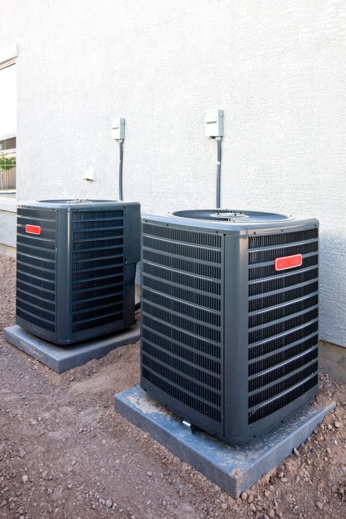 Two Goodman heat pumps placed outside the house