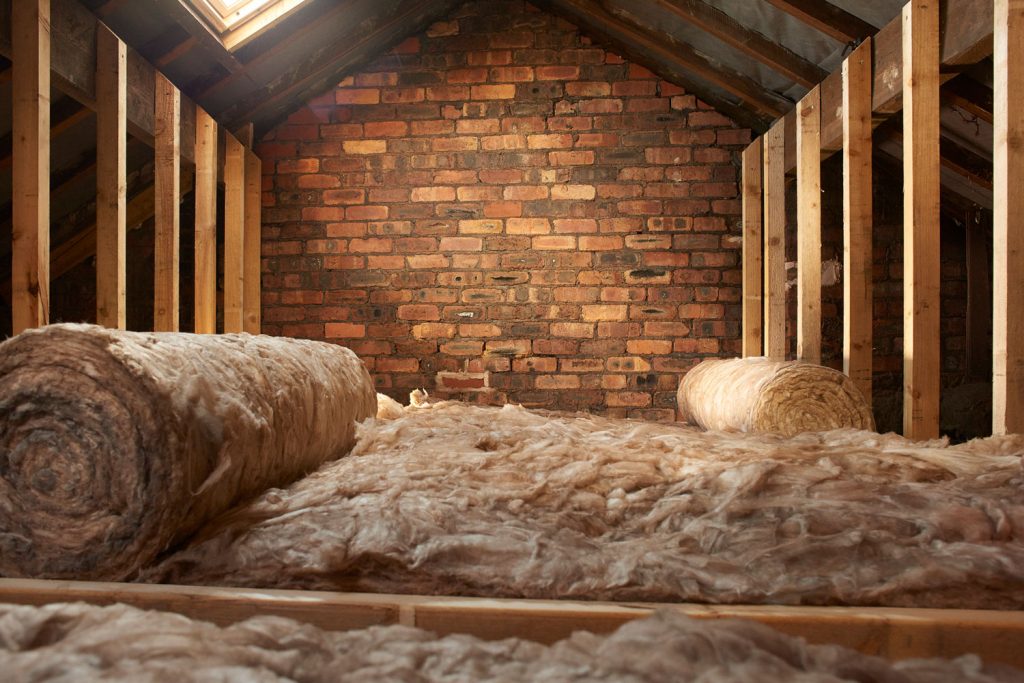 Unrolling wool insulation in the attic