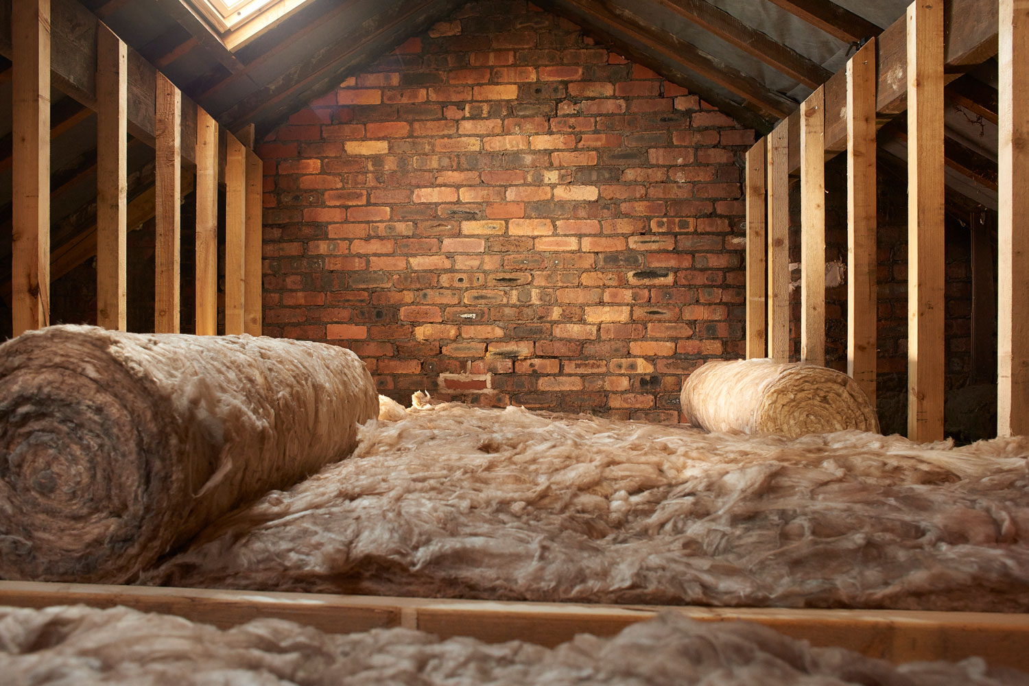 Unrolling wool insulation in the attic