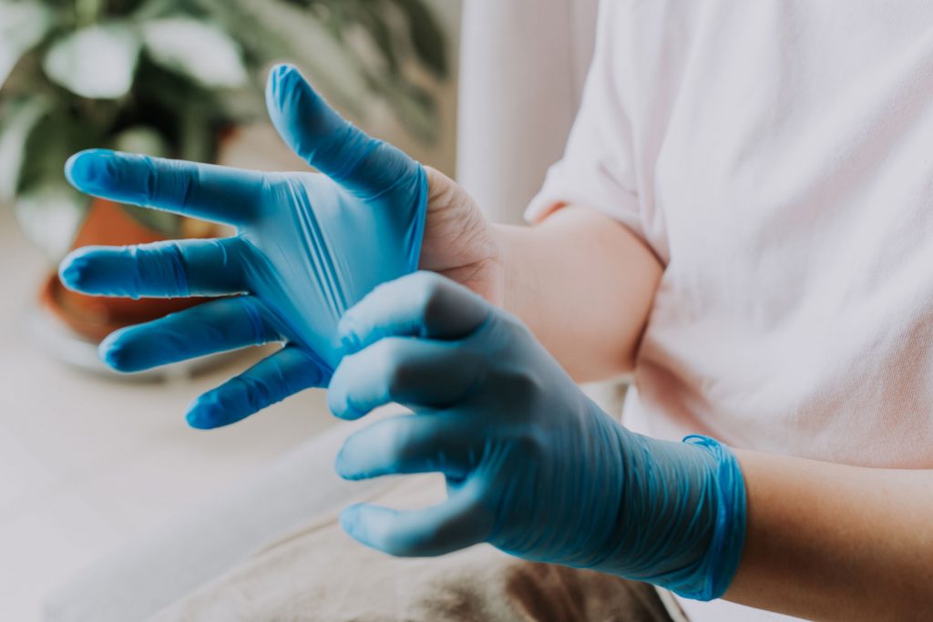 Wearing protective rubber gloves 