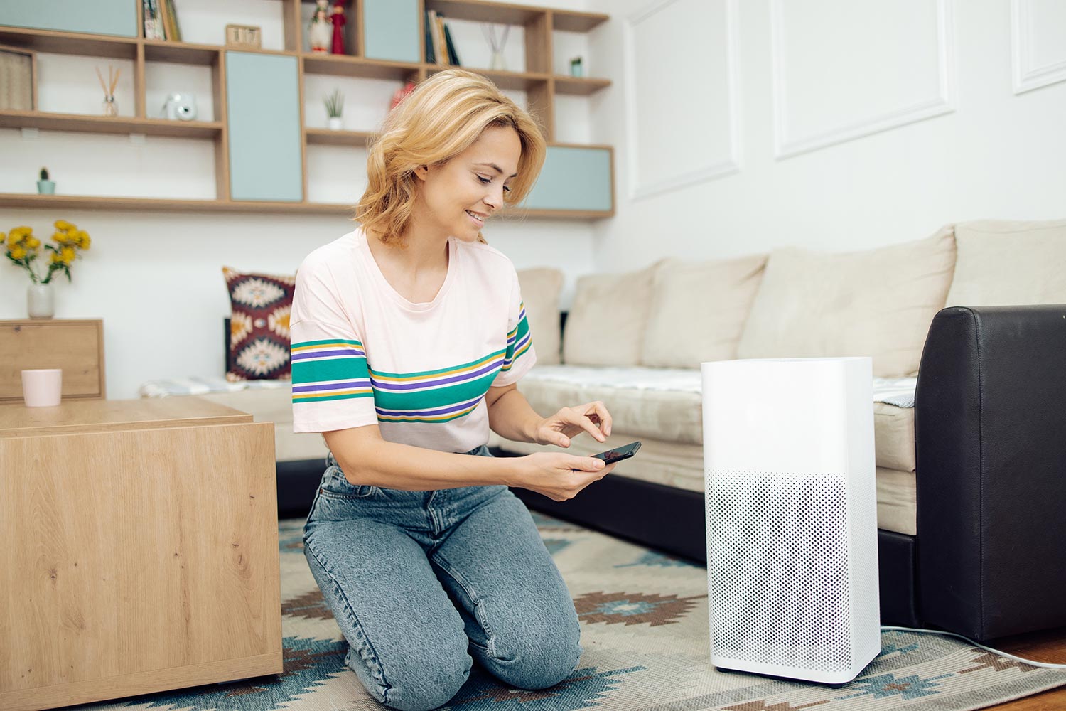 Woman adjusting a home air cleaner using a smart system