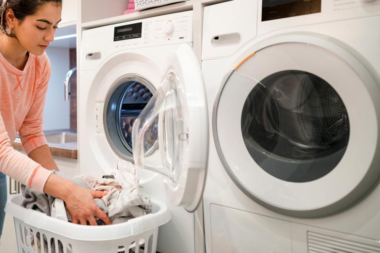 Woman doing her laundry while at home, How To Insulate The Laundry Room
