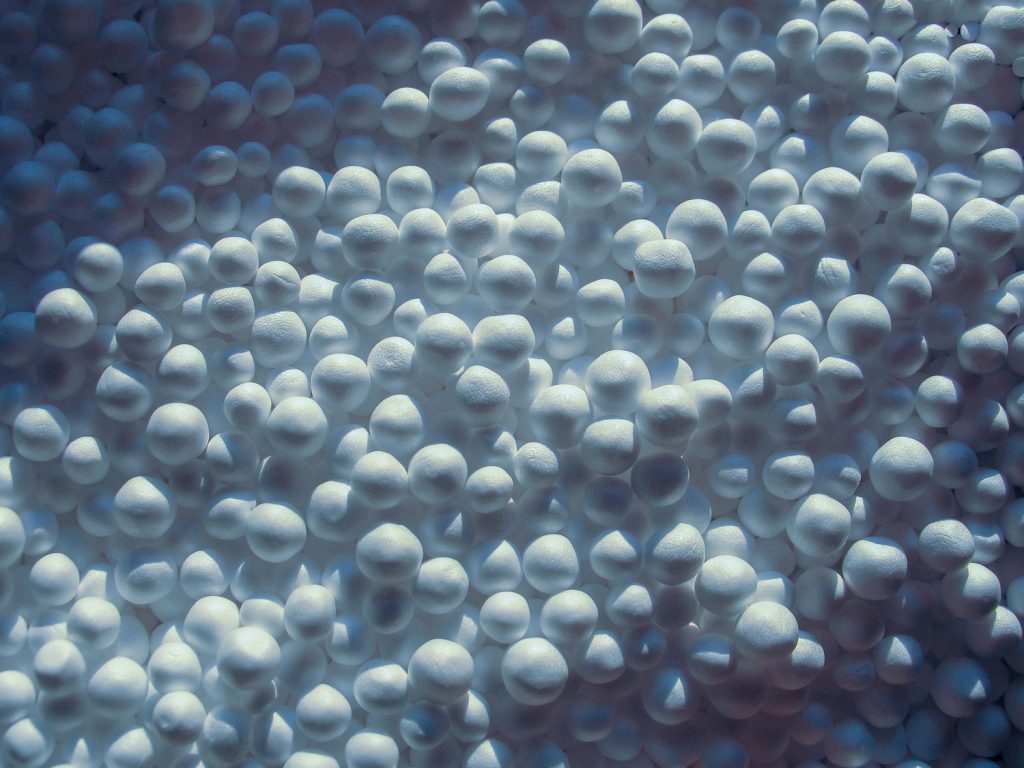 Zoomed white expanded polystyrene pellets balls for production plastic bags and films