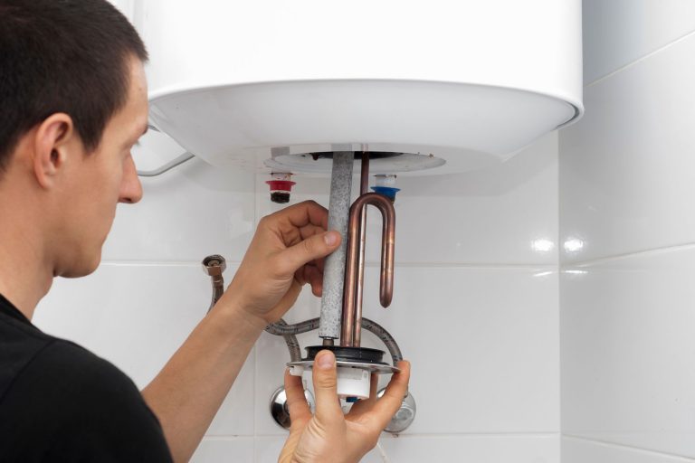 master installs a new electric heating ten in a water tank, Do You Need A Permit To Replace A Water Heater?