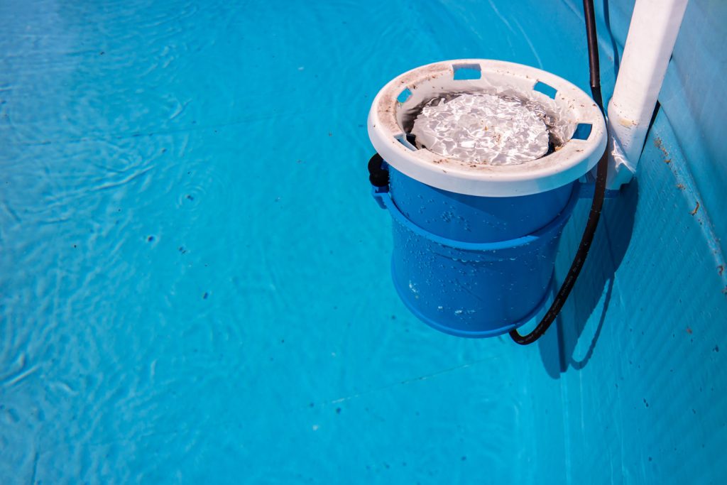 A small pool filter mounted on the side of the pool