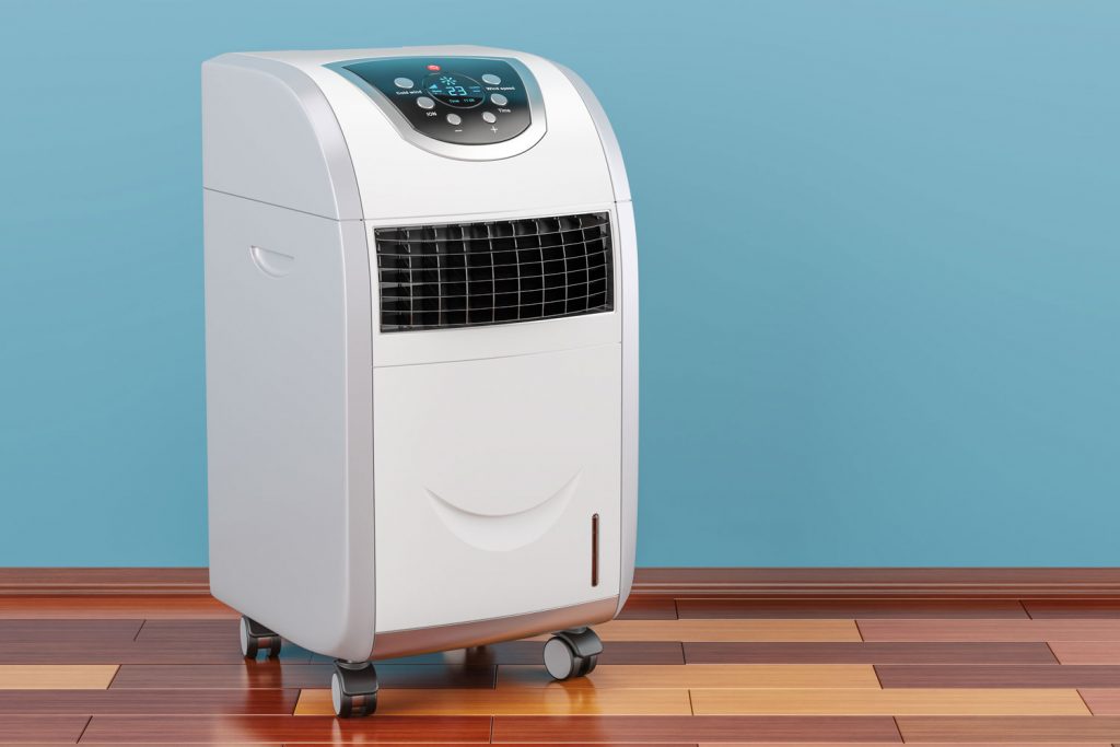 A small white portable air conditioning unit placed well in the living room
