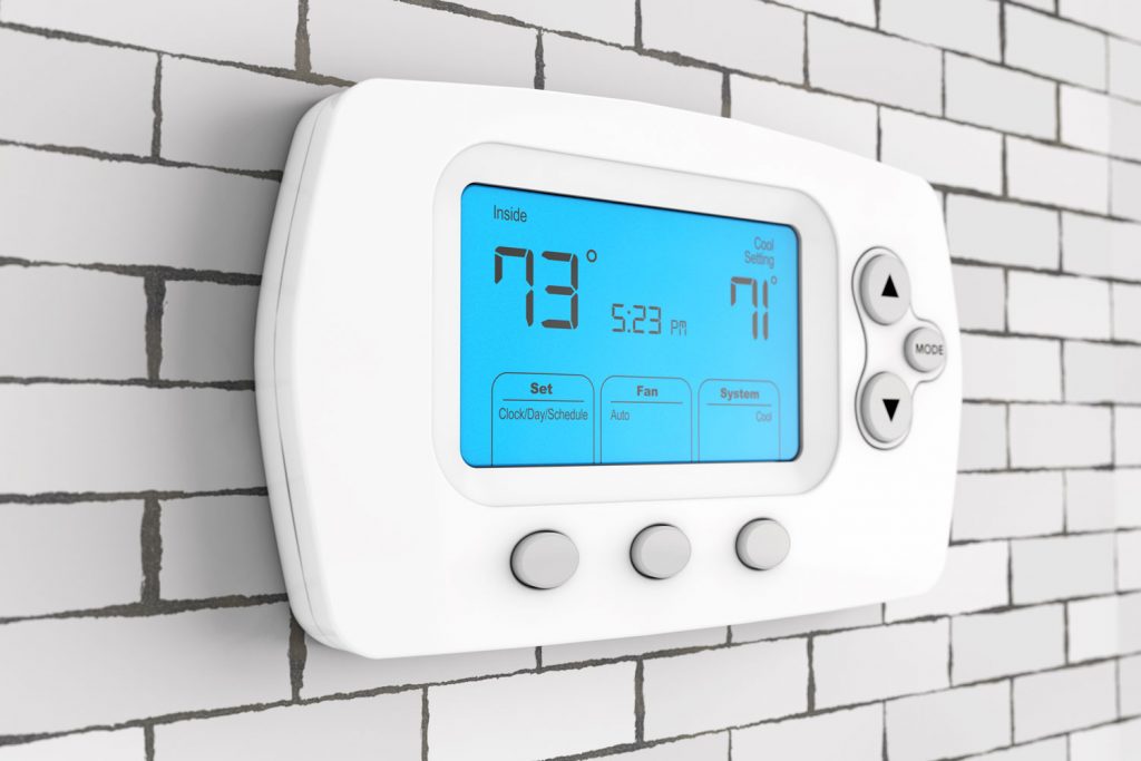A thermostat set at 73 degrees for a comfortable temperature for the living room