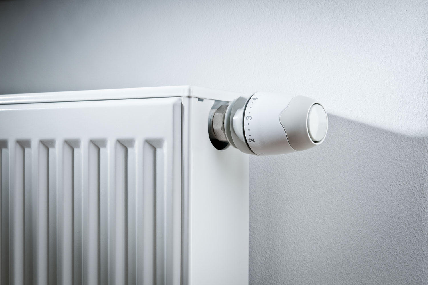 A wall heaters adjusting knob mounted on the side of the wall