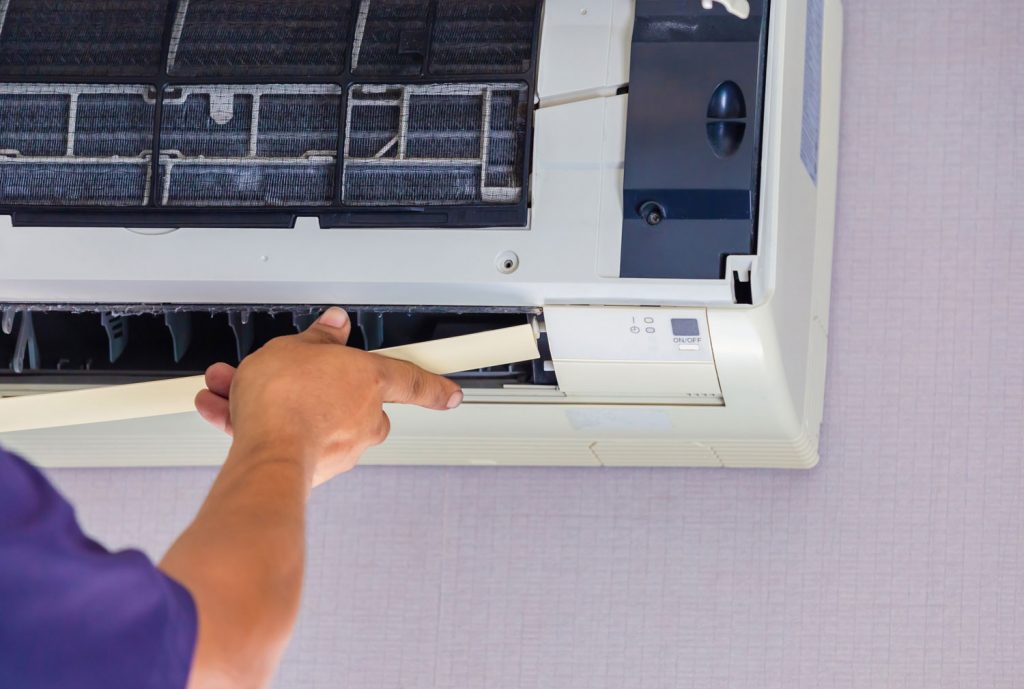 Air Conditioning Repair, Repairman fixing air conditioning system,