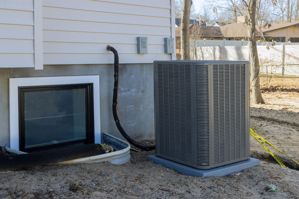 Air conditioning system unit installed outside facade of the new house the air conditioner with freon