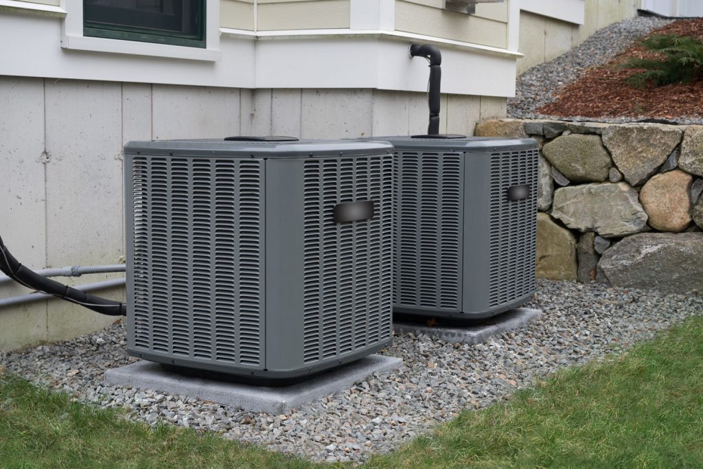 An air conditioning unit mounted on concrete pedestals