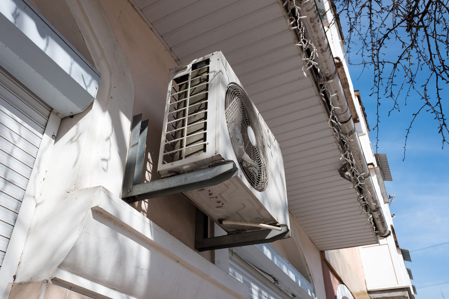 An air conditioning unit mounted on the exterior wall